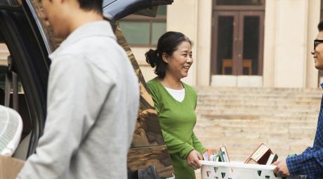 Family moving a student into dormitory on college campus